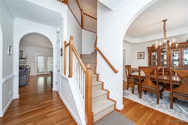 5020 Park Meadows Way, Glen Allen, VA 23059 - foyer entrance with arched walkways, ornamental molding, stairway, light wood finished floors, and a chandelier