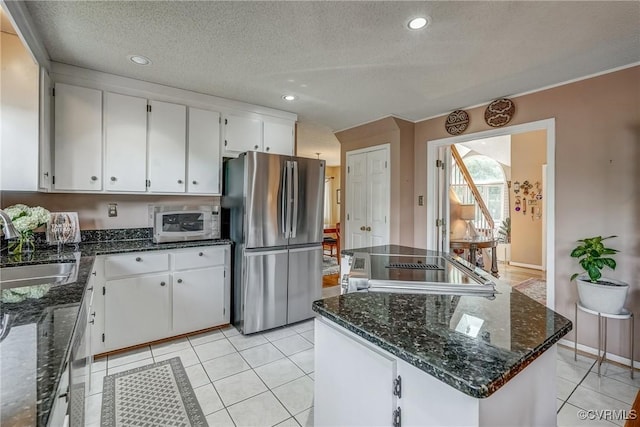 2711 Robson Ct, Henrico, VA 23233 - kitchen with appliances with stainless steel finishes, white cabinets, a kitchen island, dark stone counters, and a textured ceiling
