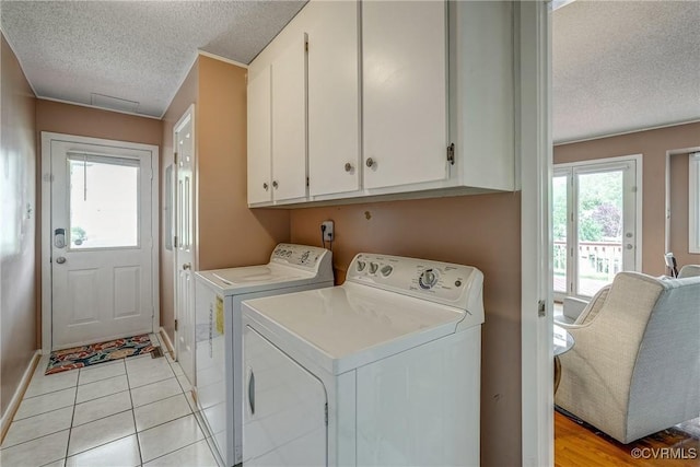 2711 Robson Ct, Henrico, VA 23233 - laundry area with a textured ceiling, cabinet space, washer and dryer, and light tile patterned floors