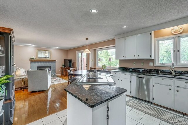 2711 Robson Ct, Henrico, VA 23233 - kitchen with stainless steel dishwasher, a center island, stove, open floor plan, and a fireplace