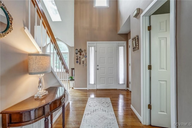 2711 Robson Ct, Henrico, VA 23233 - entrance foyer featuring stairway, a towering ceiling, a skylight, and wood finished floors
