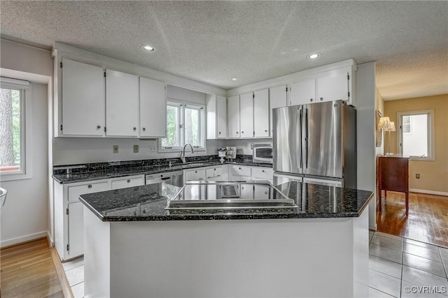 2711 Robson Ct, Henrico, VA 23233 - kitchen with stainless steel appliances, a textured ceiling, white cabinets, a kitchen island, and recessed lighting