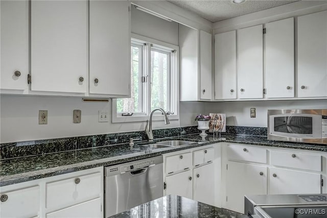 2711 Robson Ct, Henrico, VA 23233 - kitchen featuring stainless steel appliances, white cabinets, dark stone countertops, and a textured ceiling