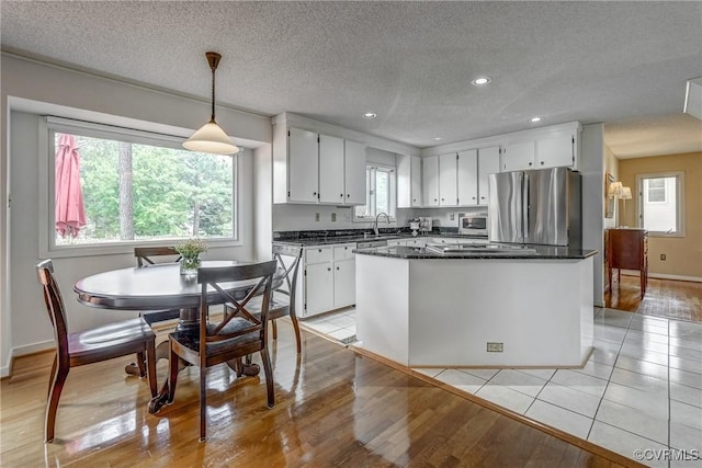 2711 Robson Ct, Henrico, VA 23233 - kitchen with stainless steel appliances, white cabinetry, recessed lighting, a kitchen island, and light wood finished floors