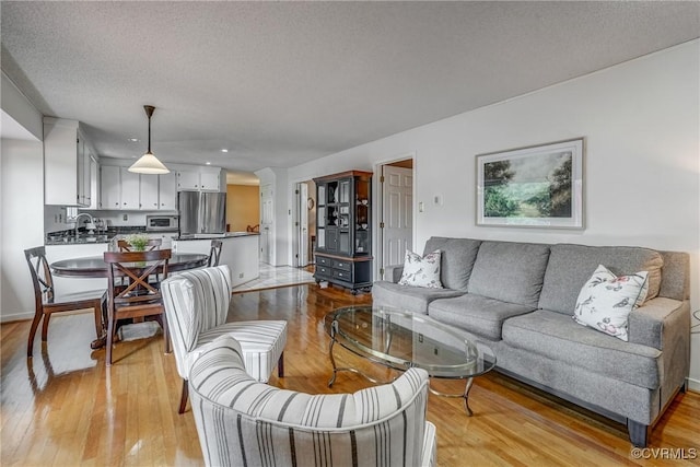 2711 Robson Ct, Henrico, VA 23233 - living room featuring light wood-type flooring and a textured ceiling