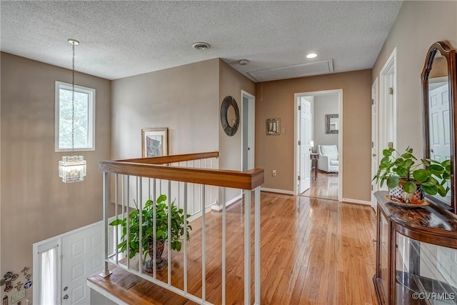 2711 Robson Ct, Henrico, VA 23233 - hall featuring light wood-style floors, a textured ceiling, an upstairs landing, and recessed lighting