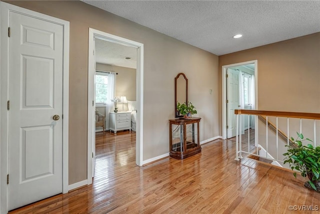2711 Robson Ct, Henrico, VA 23233 - hallway with a textured ceiling, light wood-style floors, recessed lighting, and stairs