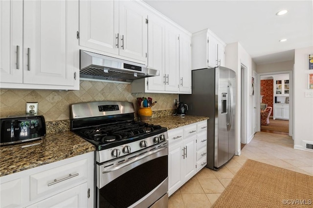 8950 Bellefonte Rd, Henrico, VA 23229 - kitchen with appliances with stainless steel finishes, under cabinet range hood, white cabinets, light tile patterned floors, and decorative backsplash