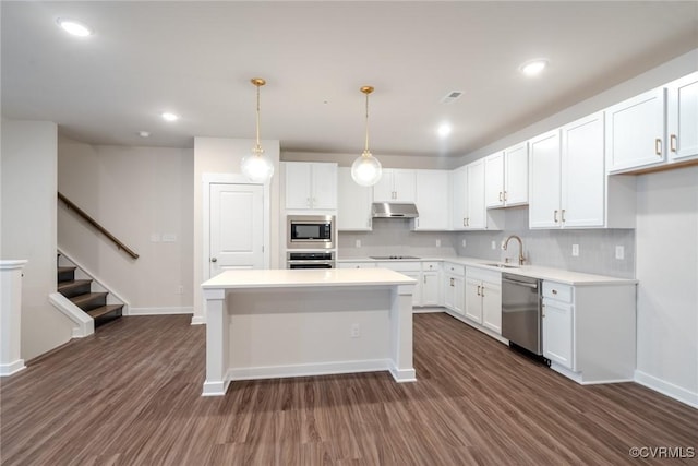 3436 Carlton St Unit 4-4A, Richmond, VA 23230 - kitchen featuring appliances with stainless steel finishes, dark wood-style floors, white cabinets, under cabinet range hood, and light countertops