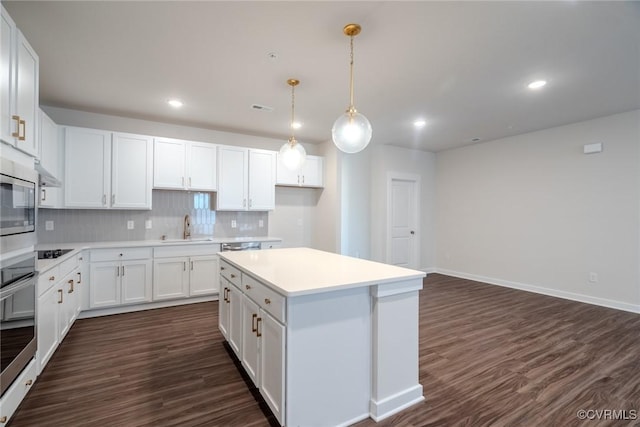 3436 Carlton St Unit 4-4A, Richmond, VA 23230 - kitchen featuring tasteful backsplash, appliances with stainless steel finishes, a kitchen island, white cabinets, and dark wood-type flooring