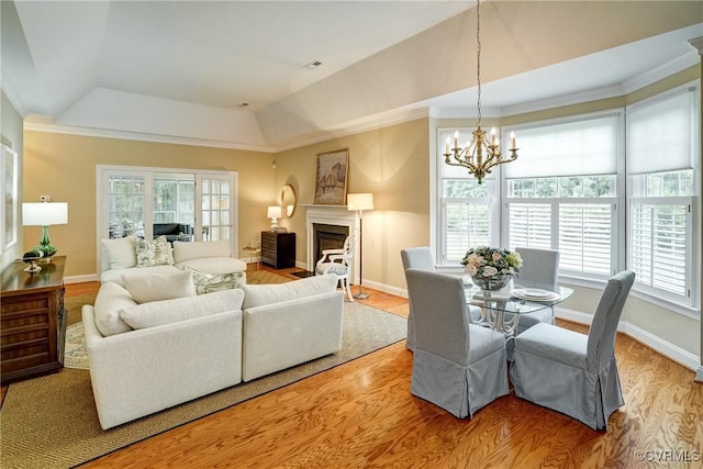 5116 Belmont Park Rd, Glen Allen, VA 23059 - living room featuring a raised ceiling, healthy amount of natural light, a chandelier, wood finished floors, and crown molding