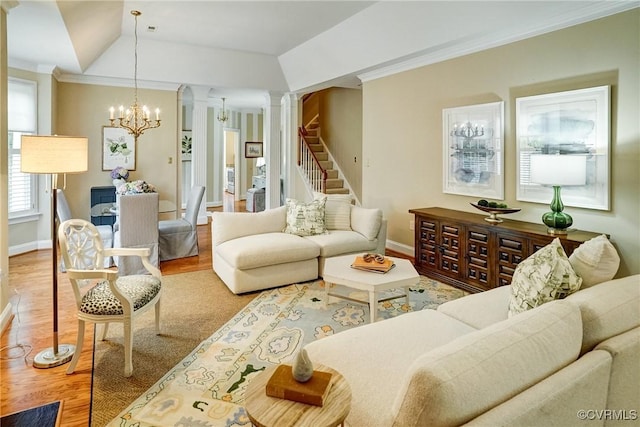 5116 Belmont Park Rd, Glen Allen, VA 23059 - living area featuring wood finished floors, a chandelier, ornate columns, stairs, and ornamental molding