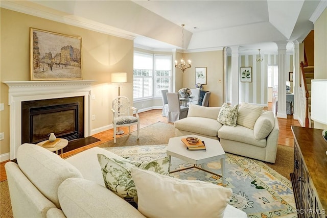 5116 Belmont Park Rd, Glen Allen, VA 23059 - living room featuring decorative columns, a chandelier, wood finished floors, a fireplace with flush hearth, and crown molding