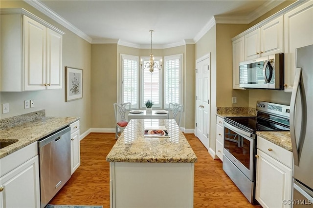 5116 Belmont Park Rd, Glen Allen, VA 23059 - kitchen featuring appliances with stainless steel finishes, a kitchen island, a chandelier, light wood-style floors, and white cabinetry