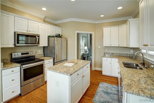 5116 Belmont Park Rd, Glen Allen, VA 23059 - kitchen with stainless steel appliances, a kitchen island, white cabinets, ornamental molding, and recessed lighting