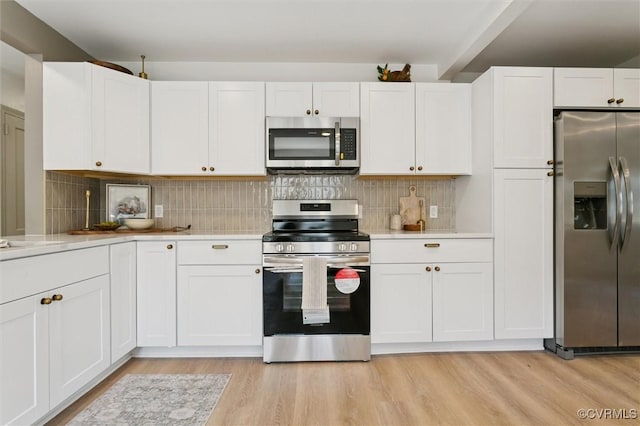 808 Penniman Rd, Williamsburg, VA 23185 - kitchen featuring stainless steel appliances, light countertops, white cabinetry, light wood finished floors, and decorative backsplash