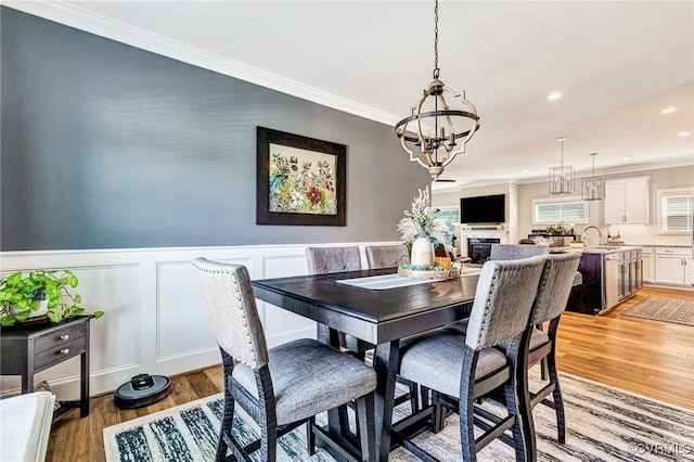 9401 Alsace Ct, Mechanicsville, VA 23116 - dining area featuring a chandelier, light wood finished floors, recessed lighting, ornamental molding, and a wainscoted wall