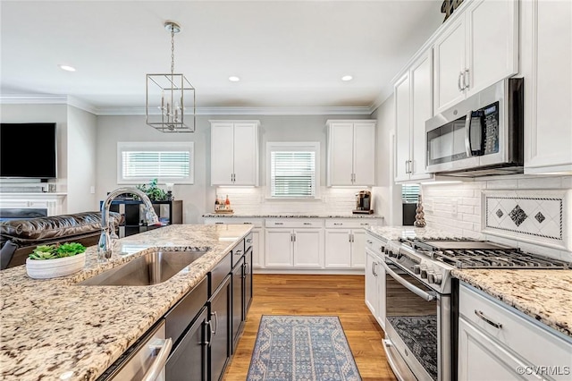 9401 Alsace Ct, Mechanicsville, VA 23116 - kitchen featuring stainless steel appliances, white cabinets, open floor plan, light wood-style floors, and recessed lighting
