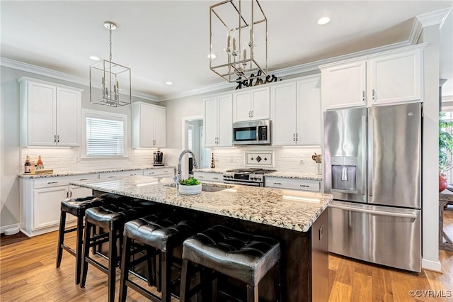 9401 Alsace Ct, Mechanicsville, VA 23116 - kitchen with appliances with stainless steel finishes, a center island with sink, white cabinets, decorative light fixtures, and ornamental molding