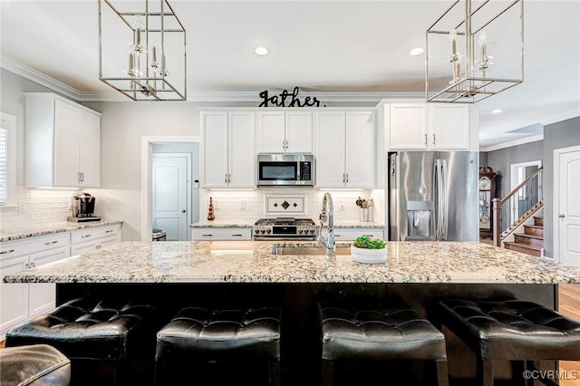 9401 Alsace Ct, Mechanicsville, VA 23116 - kitchen featuring stainless steel appliances, a chandelier, decorative backsplash, white cabinets, and light stone counters