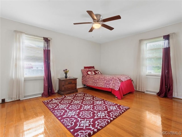 3204 Evergreen Ave, Hopewell, VA 23860 - bedroom with wood finished floors, a ceiling fan, and baseboard heating
