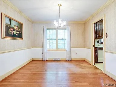 1600 Donora Ct, Henrico, VA 23229 - unfurnished dining area featuring crown molding, a chandelier, and light wood-style flooring