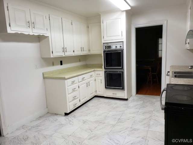 1600 Donora Ct, Henrico, VA 23229 - kitchen with double wall oven, black / electric stove, white cabinetry, light countertops, and light marble finish floors