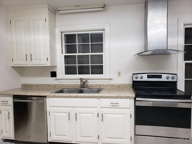 1600 Donora Ct, Henrico, VA 23229 - kitchen featuring appliances with stainless steel finishes, wall chimney range hood, white cabinetry, and light countertops