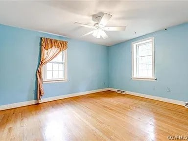 1600 Donora Ct, Henrico, VA 23229 - empty room with healthy amount of natural light, wood finished floors, and ceiling fan
