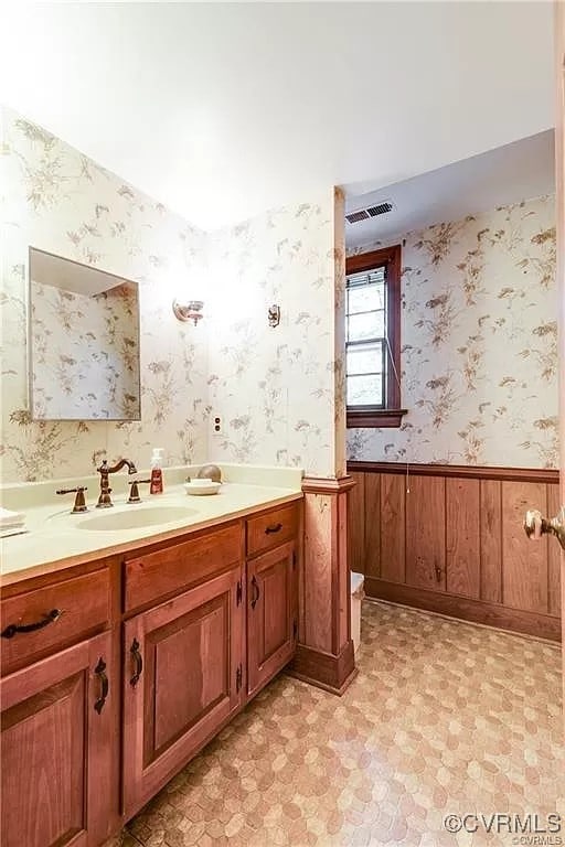1600 Donora Ct, Henrico, VA 23229 - bathroom with vanity, wainscoting, wallpapered walls, and tile patterned floors