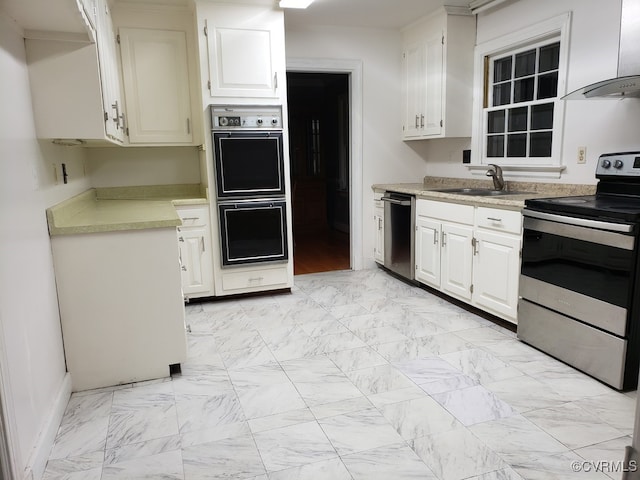 1600 Donora Ct, Henrico, VA 23229 - kitchen with appliances with stainless steel finishes, wall chimney range hood, light countertops, and white cabinets