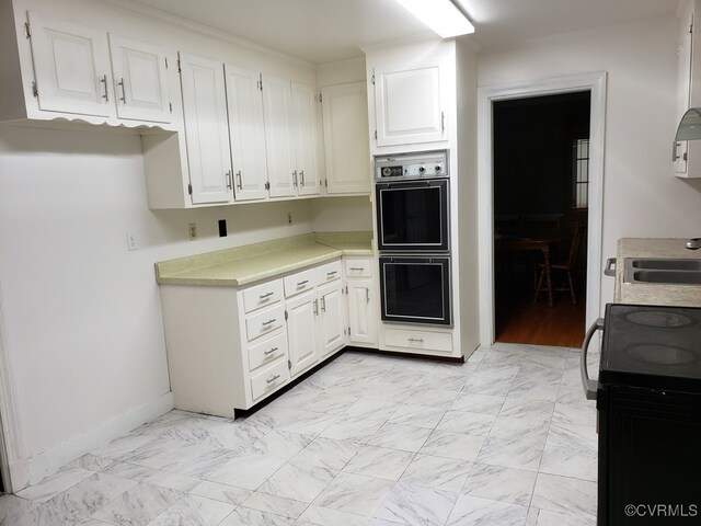 1600 Donora Ct, Henrico, VA 23229 - kitchen with double wall oven, black / electric stove, white cabinetry, light countertops, and light marble finish floors