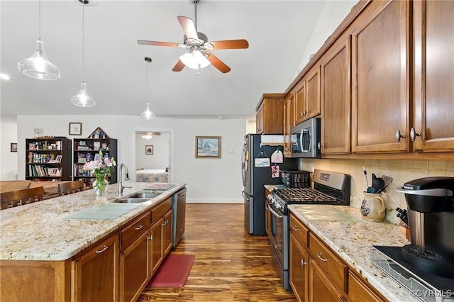 112 Rosemary Ct, Tappahannock, VA 22560 - kitchen with stainless steel appliances, a ceiling fan, brown cabinets, decorative backsplash, and vaulted ceiling