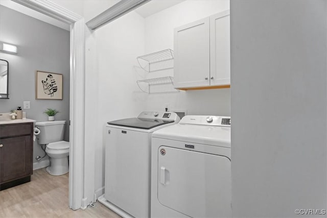 1808 N 20th St, Richmond, VA 23223 - washroom featuring washer and clothes dryer, cabinet space, and light wood finished floors