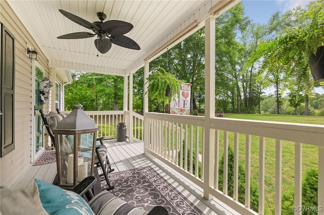 14231 Dykeland Rd, Amelia Courthouse, VA 23002 - wooden porch with a ceiling fan, a lawn, and view of scattered trees