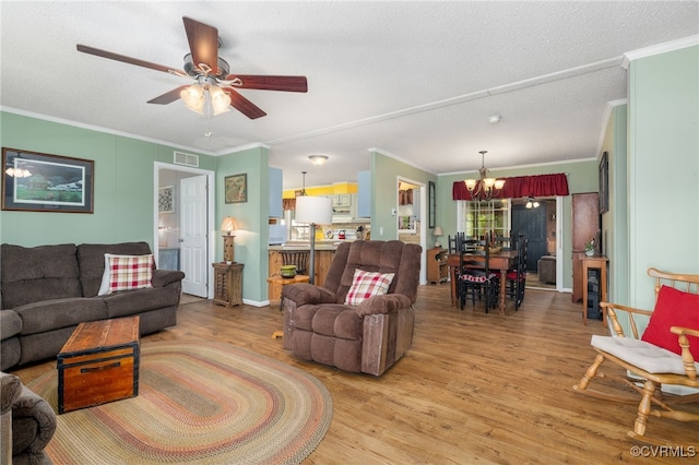 14231 Dykeland Rd, Amelia Courthouse, VA 23002 - living room featuring a chandelier, ornamental molding, light wood-style flooring, ceiling fan, and a textured ceiling