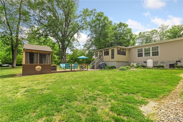 14231 Dykeland Rd, Amelia Courthouse, VA 23002 - view of green lawn with a sunroom