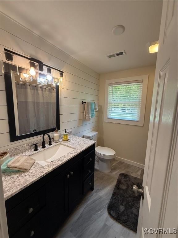 616 Long Point Ln, Topping, VA 23169 - bathroom featuring wood walls, vanity, and a shower with curtain
