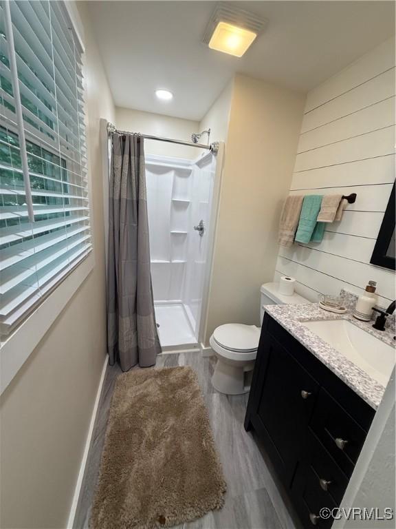 616 Long Point Ln, Topping, VA 23169 - full bathroom featuring a stall shower, vanity, and wood finished floors