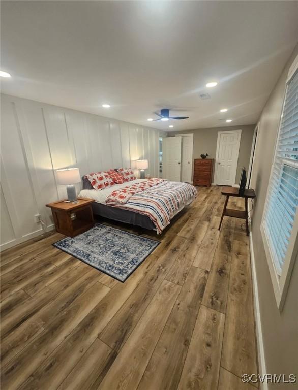 616 Long Point Ln, Topping, VA 23169 - bedroom with wood-type flooring, recessed lighting, a decorative wall, and a ceiling fan