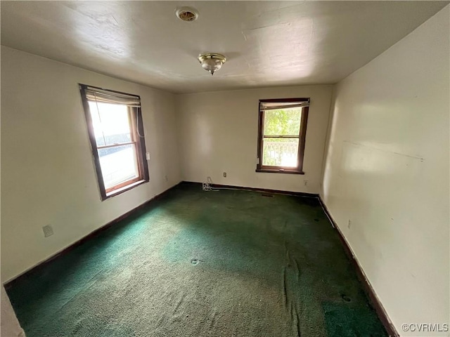 511 Hannon St, Petersburg, VA 23803 - empty room with baseboards and dark colored carpet