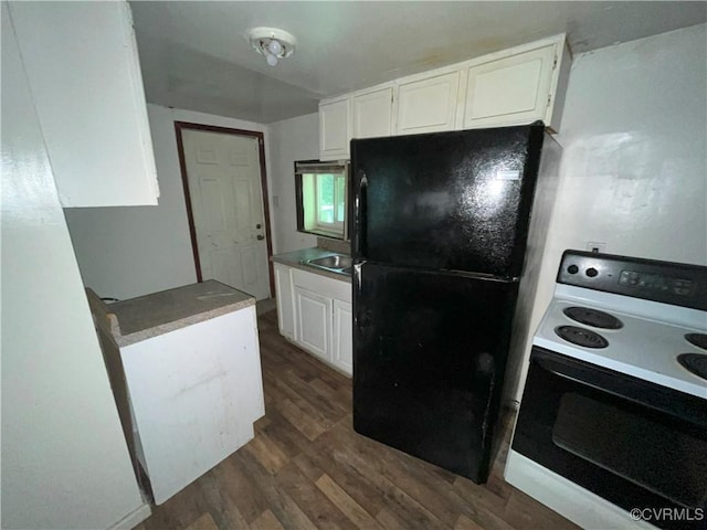 511 Hannon St, Petersburg, VA 23803 - kitchen with electric stove, freestanding refrigerator, white cabinets, and dark wood finished floors