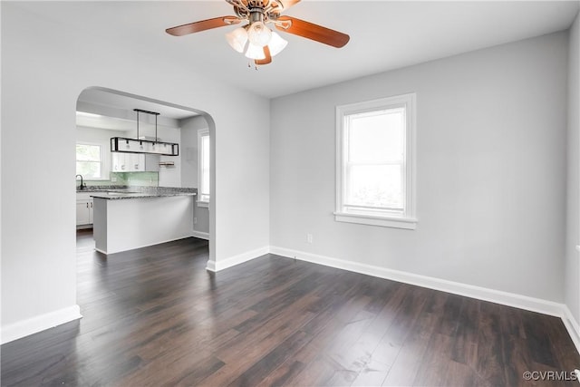 2149 Park Ln, Henrico, VA 23230 - unfurnished living room featuring arched walkways, dark wood-type flooring, and ceiling fan