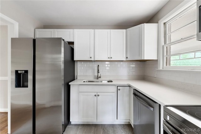 6817 W Grace St, Richmond, VA 23226 - kitchen featuring stainless steel appliances, white cabinetry, light wood finished floors, and light countertops