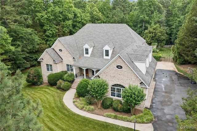 3631 Cannon Ridge Ct, Midlothian, VA 23113 - view of front of property featuring a front lawn, a forest view, covered porch, and stone siding