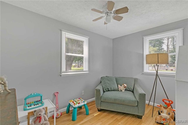 7284 Farinholt St, Gloucester, VA 23061 - sitting room featuring wood finished floors, a textured ceiling, and a ceiling fan