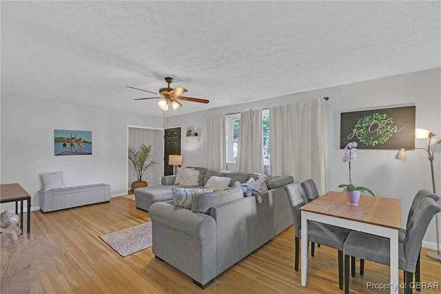 7284 Farinholt St, Gloucester, VA 23061 - living area with a ceiling fan, light wood-style flooring, and a textured ceiling