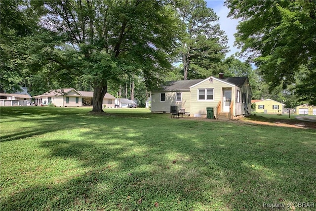 7284 Farinholt St, Gloucester, VA 23061 - view of green lawn with entry steps and view of scattered trees