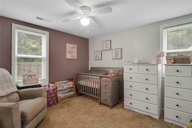 3315 Romancoke Ave, West Point, VA 23181 - bedroom with light carpet, a nursery area, and a ceiling fan