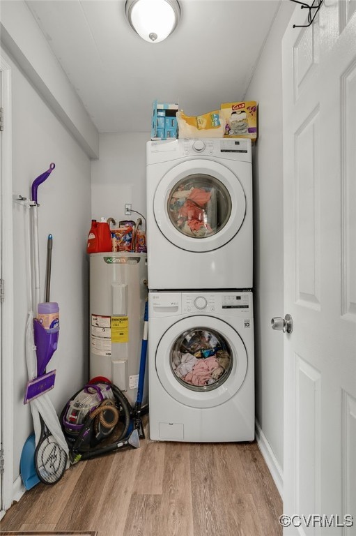 3315 Romancoke Ave, West Point, VA 23181 - laundry area featuring estacked washer and dryer, water heater, and wood finished floors
